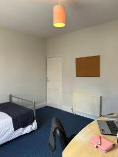 A bright and inviting double bedroom featuring ...