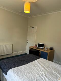 This inviting double bedroom features a cozy la...