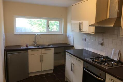 Bright and modern kitchen featuring ample stora...