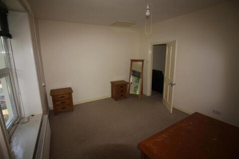 This spacious double bedroom features ample nat...