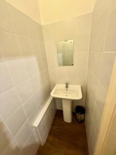 Compact and functional single toilet room featu...