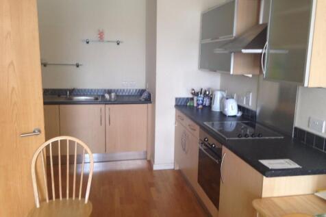 Well-maintained kitchen with modern wooden cabi...