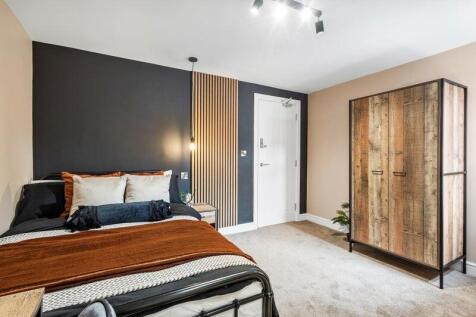 A stylish double bedroom featuring a comfortabl...
