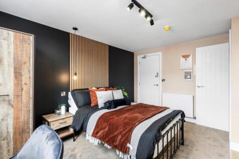 A stylish double bedroom featuring a cozy doubl...