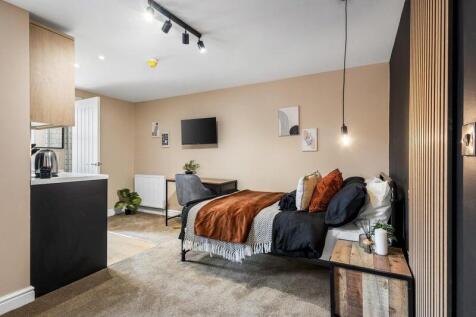 A stylish and cozy single bedroom featuring a c...