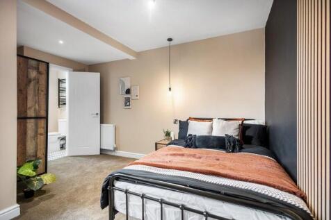 Bright and cozy double bedroom featuring a comf...