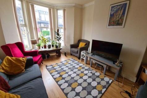 A bright and inviting living room featuring a l...