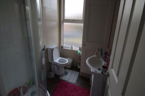 A clean and functional bathroom featuring a sho...