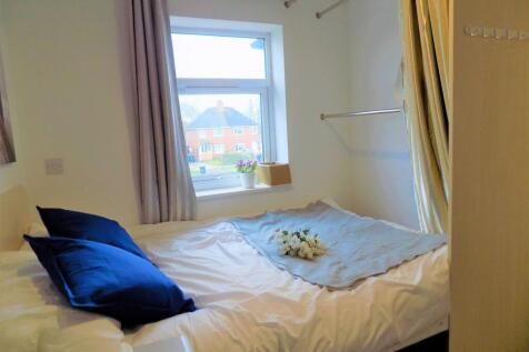 Cozy double bedroom featuring a comfortable bed...