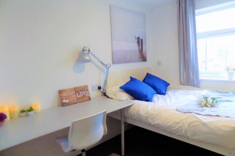 A bright and tidy single bedroom featuring a co...