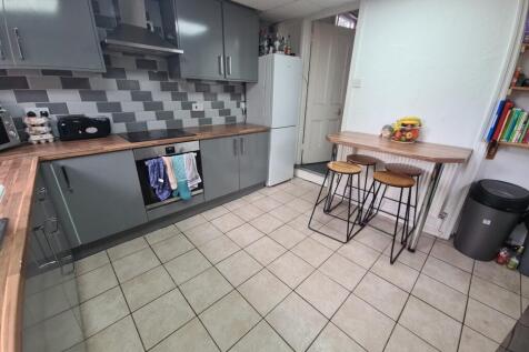 A modern kitchen featuring sleek grey cabinetry...