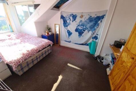 A bright and inviting master bedroom featuring ...