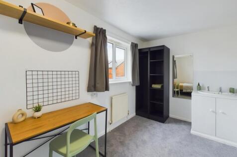 A bright and tidy double bedroom featuring a st...