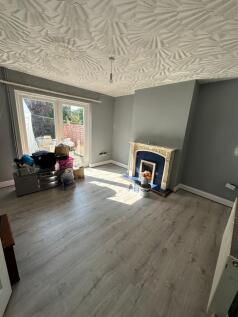 A bright and airy living room featuring light w...