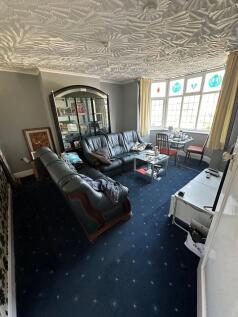 A cozy living room featuring classic leather so...