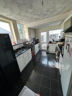 Bright kitchen featuring sleek black countertop...