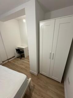 A cozy double bedroom featuring a comfortable b...