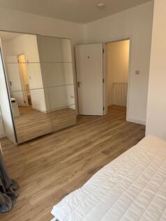 This spacious double bedroom features a large m...