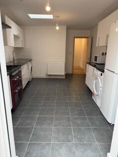 Spacious kitchen featuring modern appliances, a...