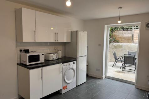 Modern and stylish kitchen featuring sleek cabi...