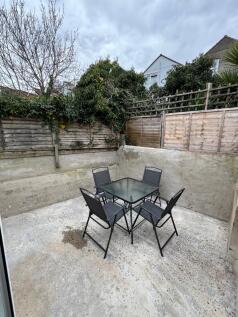 A charming garden space featuring a stylish tab...