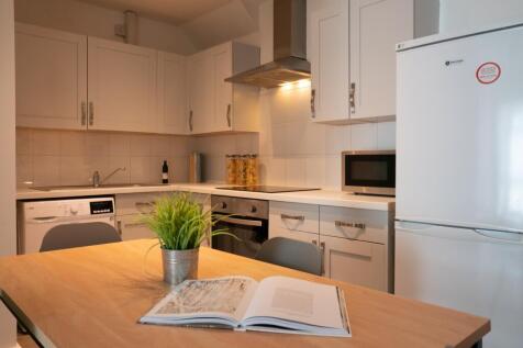 Bright and modern kitchen with ample storage, f...