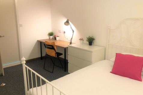 A bright and tidy single bedroom featuring a wh...