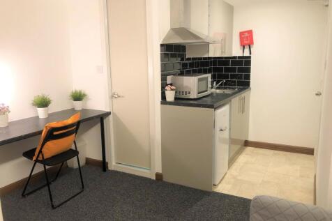 A compact and tidy kitchen area featuring a sma...