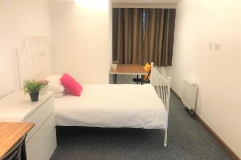 A bright and tidy single bedroom featuring a wh...