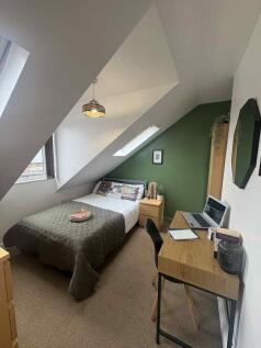 A cozy and well-maintained double bedroom featu...