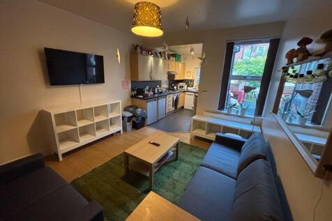 A bright and inviting living room featuring a c...