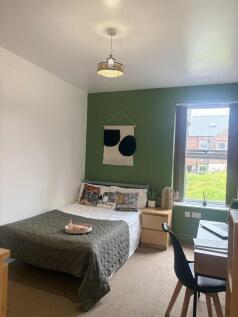 A cozy and well-maintained double bedroom featu...