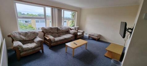 A cozy living room featuring a set of floral up...