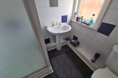 Bright and clean bathroom featuring a pedestal ...