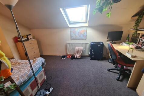 A bright and tidy single bedroom featuring a sk...
