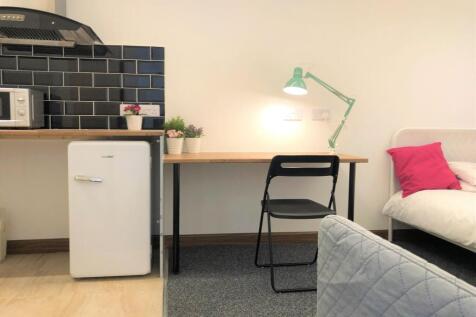 A neat and well-lit student bedroom corner feat...