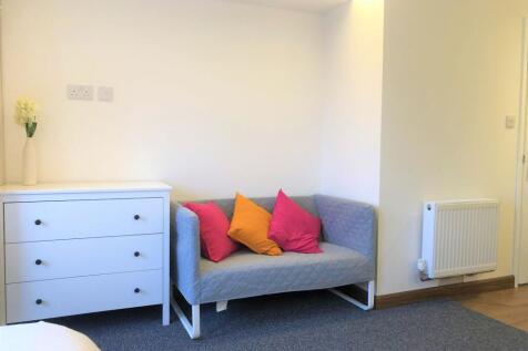 A cozy living room corner featuring a modern gr...