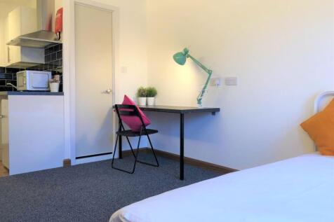 A bright and tidy single bedroom featuring a co...