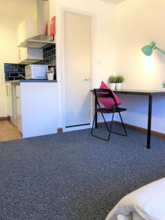 A neat and functional student bedroom featuring...