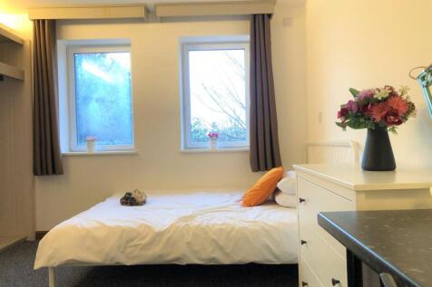 A clean and tidy single bedroom featuring two l...