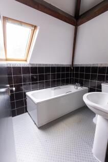 Bright and clean bathroom featuring a spacious ...
