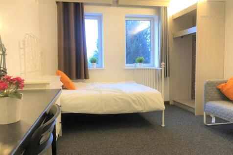 Bright and cozy double bedroom featuring two la...