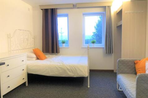 A tidy and bright single bedroom featuring two ...