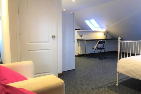 A bright and inviting master bedroom featuring ...