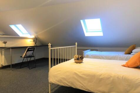 Bright and cozy double bedroom featuring two co...