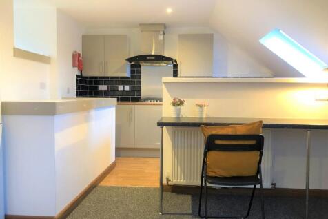 Modern kitchen area with sleek grey cabinetry a...