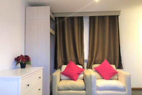 A cozy communal lounge featuring two comfortabl...