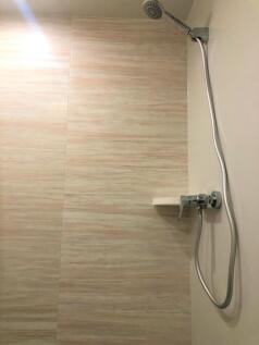 A clean, modern shower area featuring a sleek c...