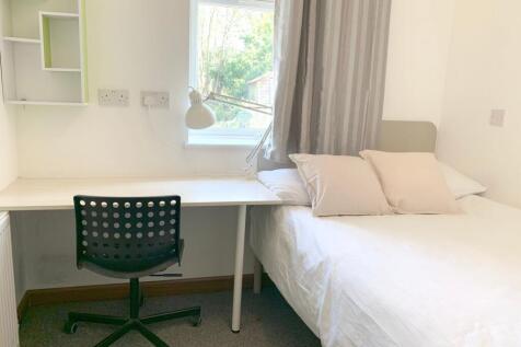 A bright and tidy single bedroom featuring a co...