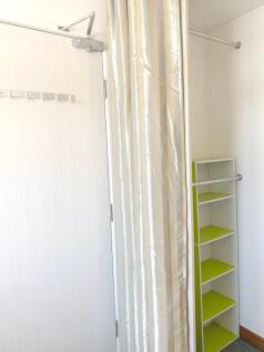 A neat and well-lit storage area featuring a co...